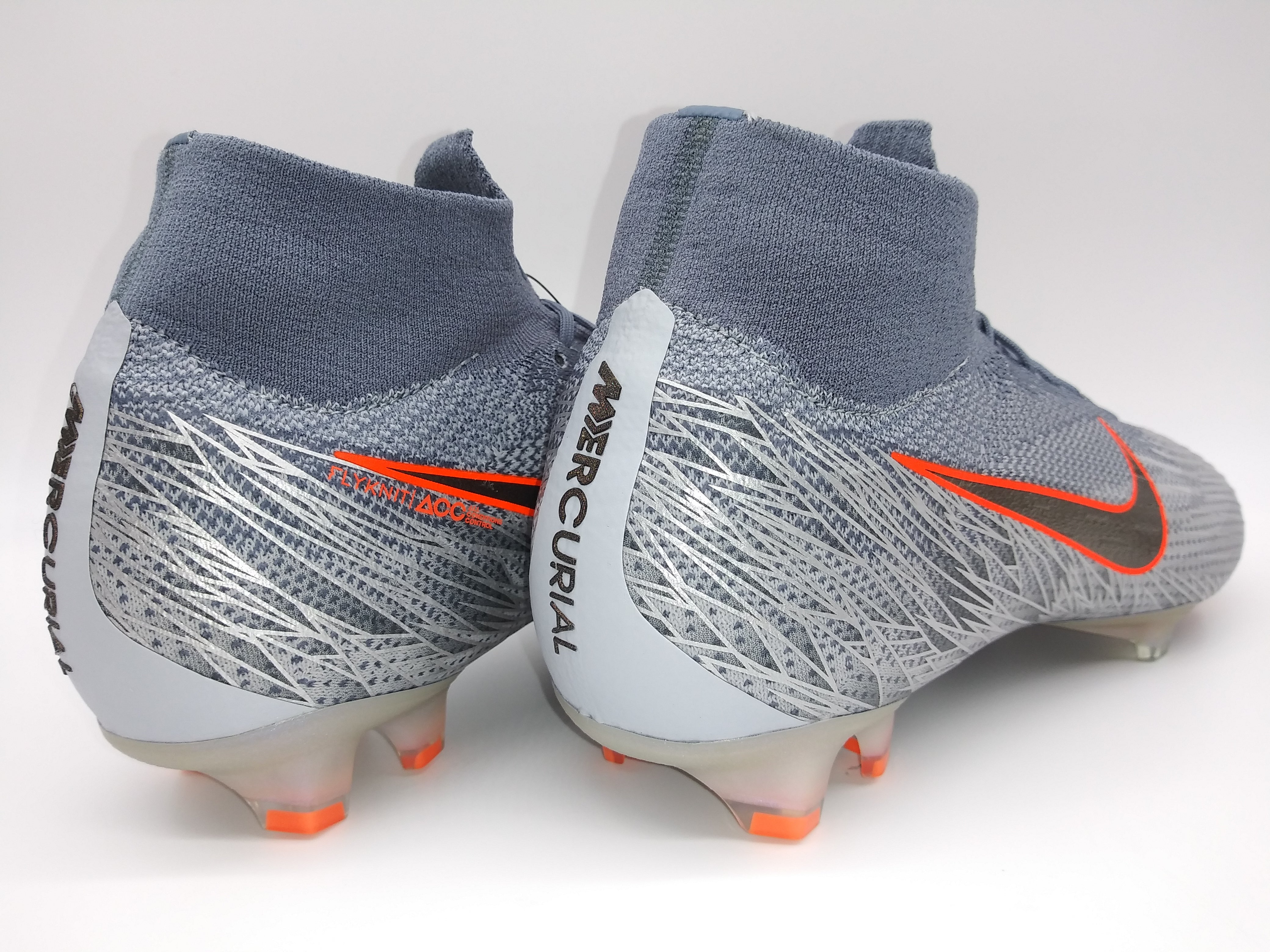 Grey and orange top nike cleats