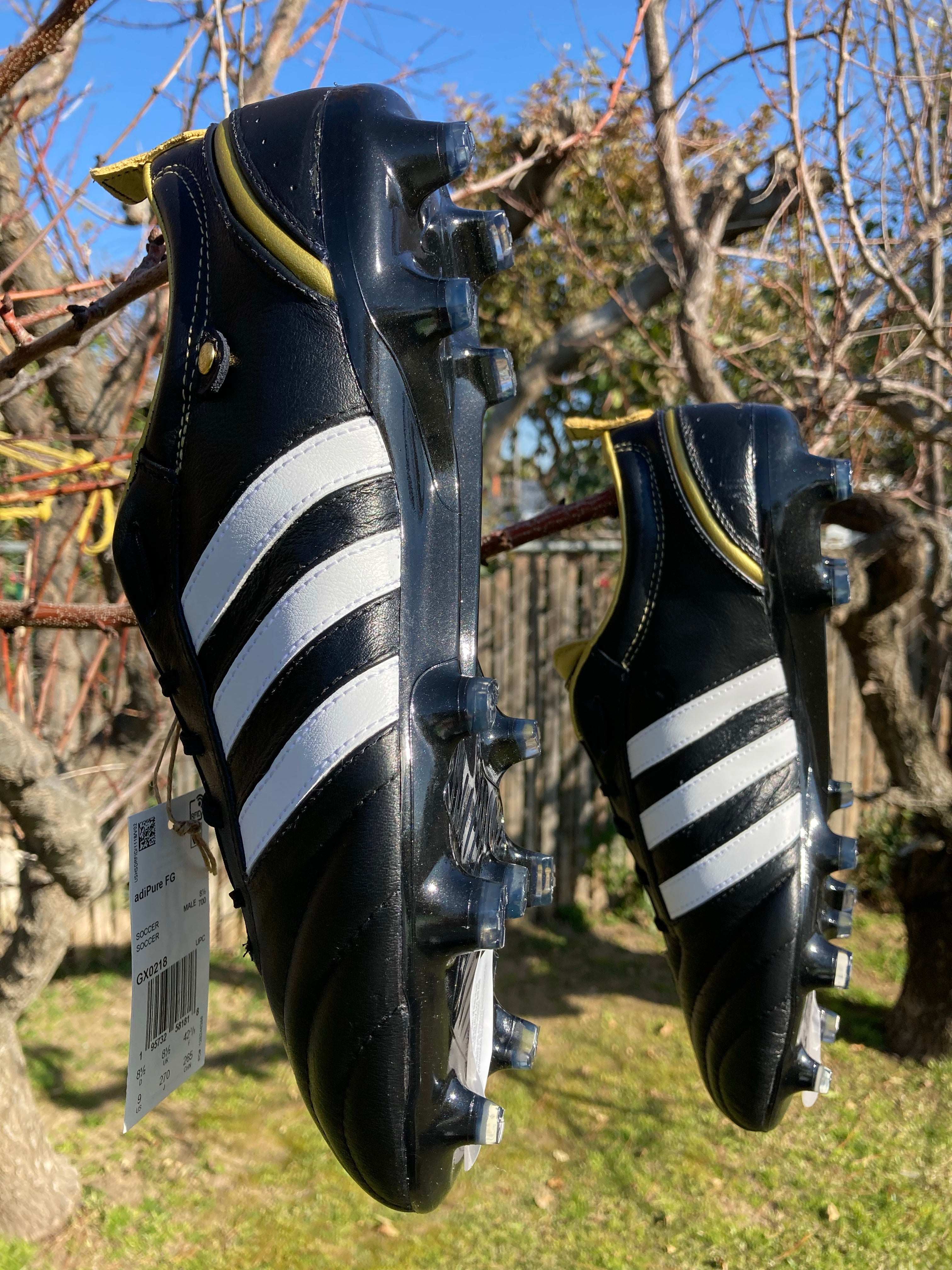 Adidas black outlet and gold cleats